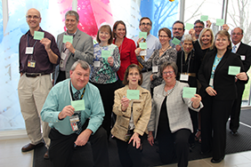 Representatives from Iowas public health system and
the lab hold green cards to give the
states laboratory system an Optimal rating during a
Laboratory Systems Improvement Program.