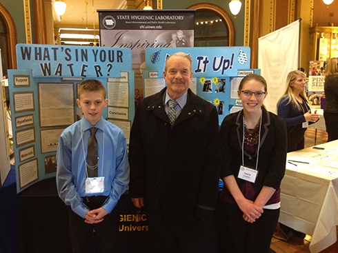 Students Luke McKenna and Laura Stowater from Algona Middle School and Algona High School (respectively) pose with State Rep. Tedd Gassman during a STEM Hill Day event at the State Capitol. McKenna and Stowater worked with mentor Dennis Heimdal, environmental lab specialist, on water quality projects in Lake Okoboji.

